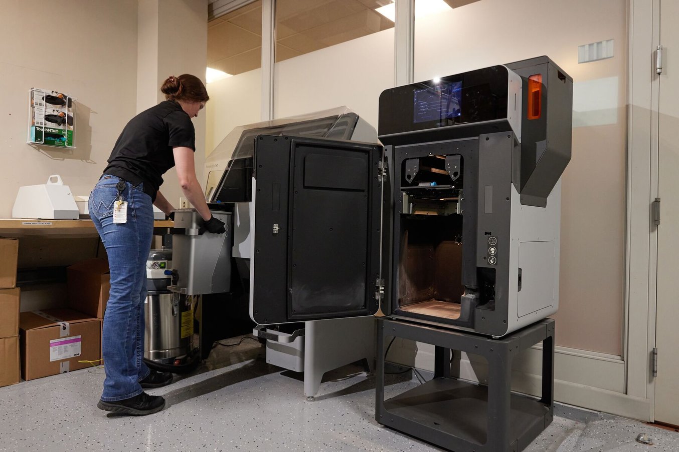 一名伊頓公司的女員工從Fuse打印機中取出一個列印腔，準備將其插入Fuse Sift打印機